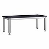 an elongated table frame made of aluminium profile of square cross-section, on four table legs and laid with a massive dark natural stone slab table top, mounted on stainless steel levelling elements screwed into the table legs, isolated on white background