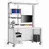 a mobile work table made of aluminium profiles on fastenable & turnable wheels, with workstation pc, laser printer, ventilator, monitor mounted on crossbar on eye level, storage in the overhead area and bright-luminous LED tube, isolated on white background